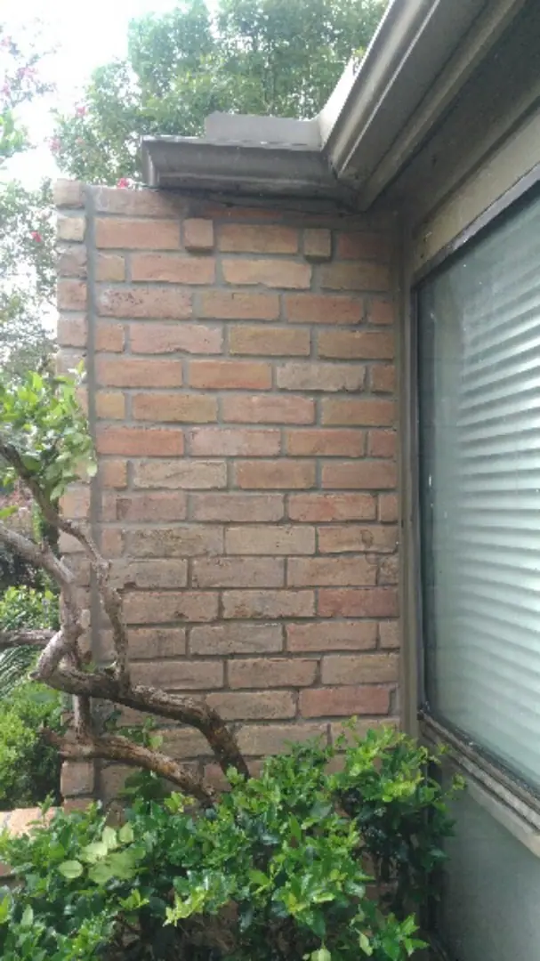Brick veneer beside the window rebuilt to the eave