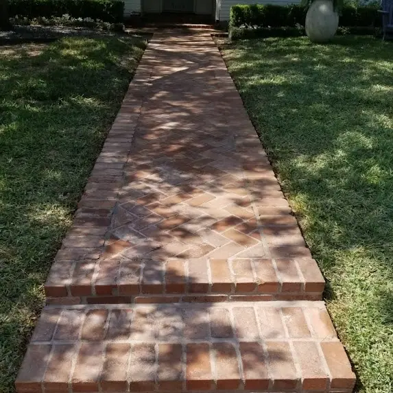 New red brick walkway leading to a front door