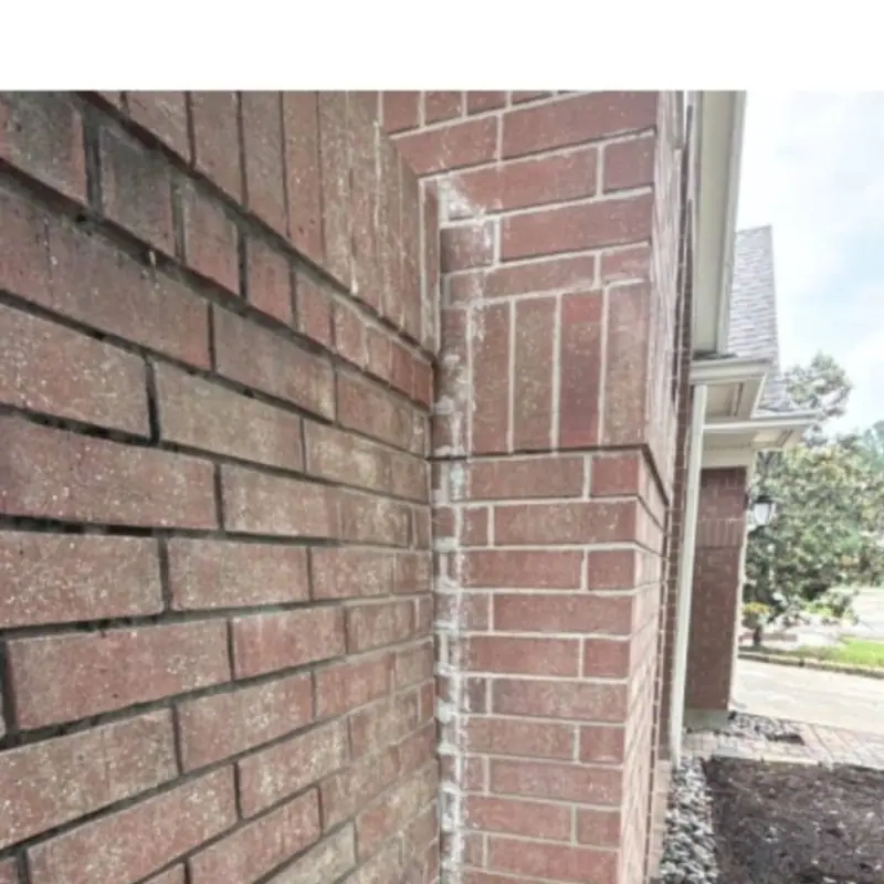 Vertical separation opening where a brick wall meets a house corner