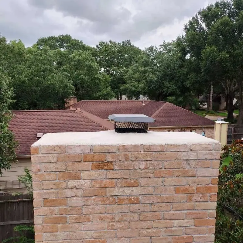 Light brick chimney after restoration with a new cap