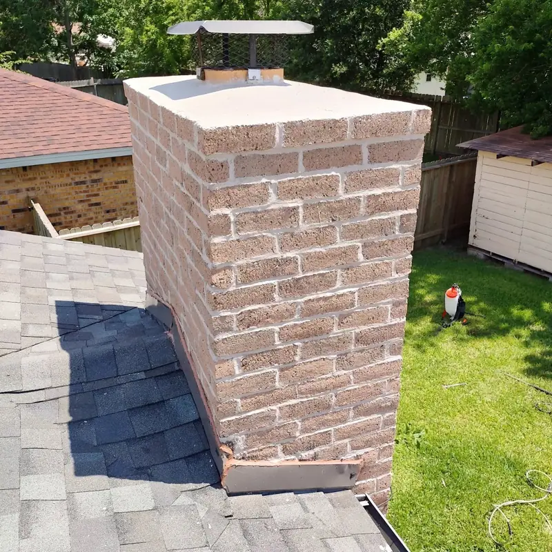 Light brick chimney with a new cap and flashing