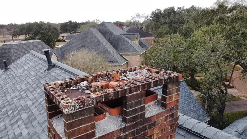 Deteriorated and missing brick at the top of a chimney, seen from above