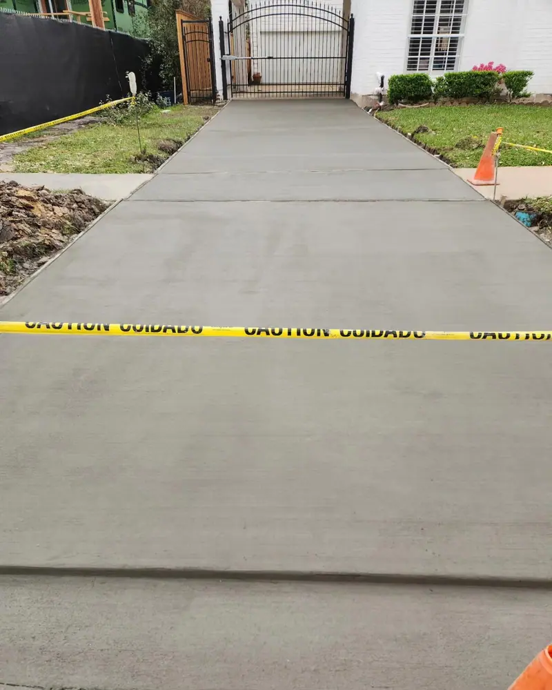 New concrete driveway curing behind caution tape