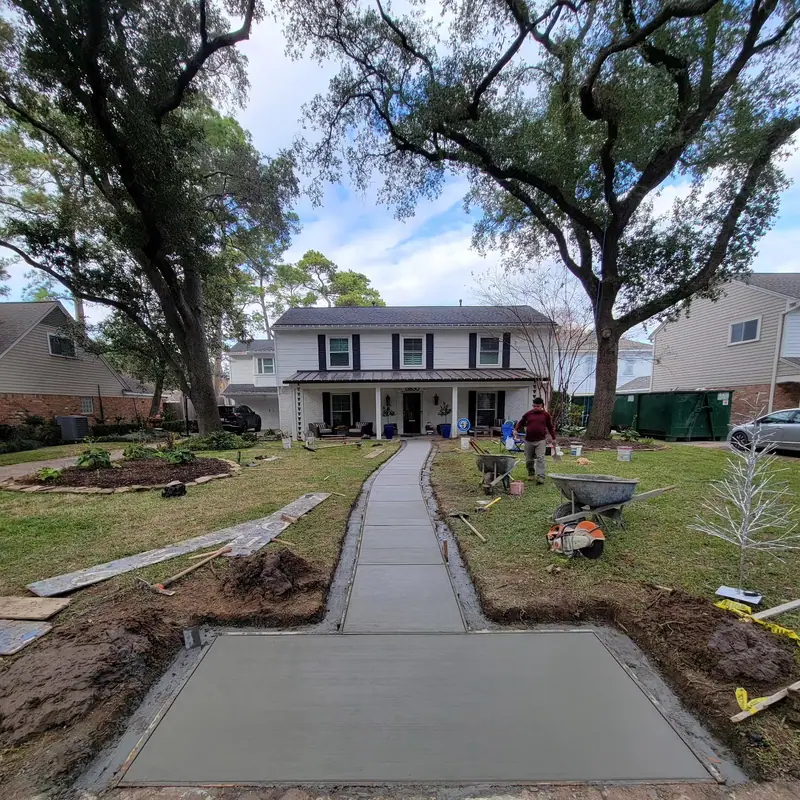 Crew finishing a new concrete front walkway