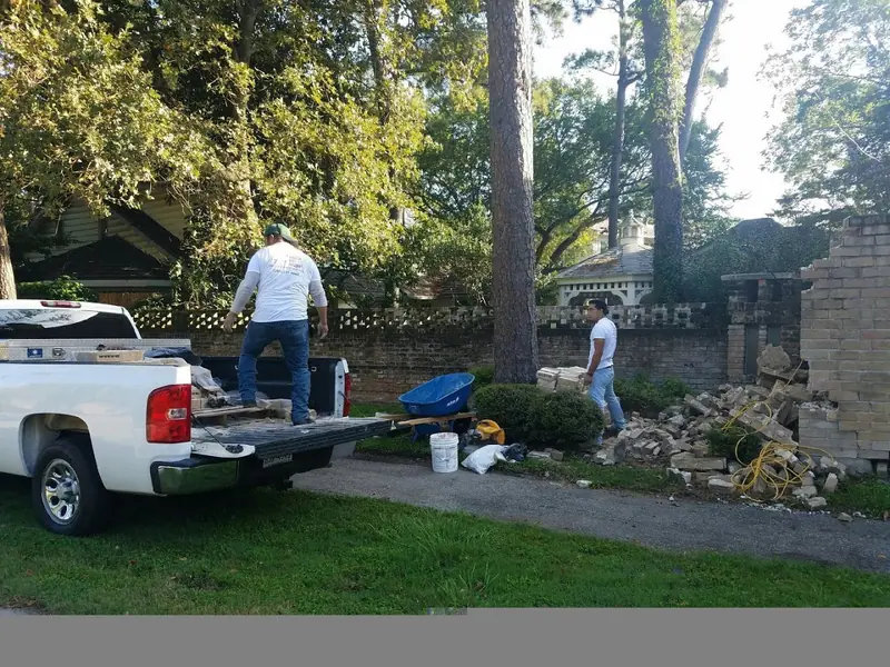 Houston Pro Masonry crew working beside a pickup truck at a job site