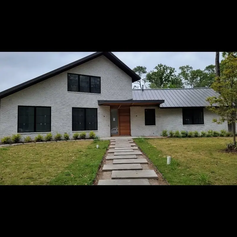 Modern home with white-finished brick and a stepping-stone walkway