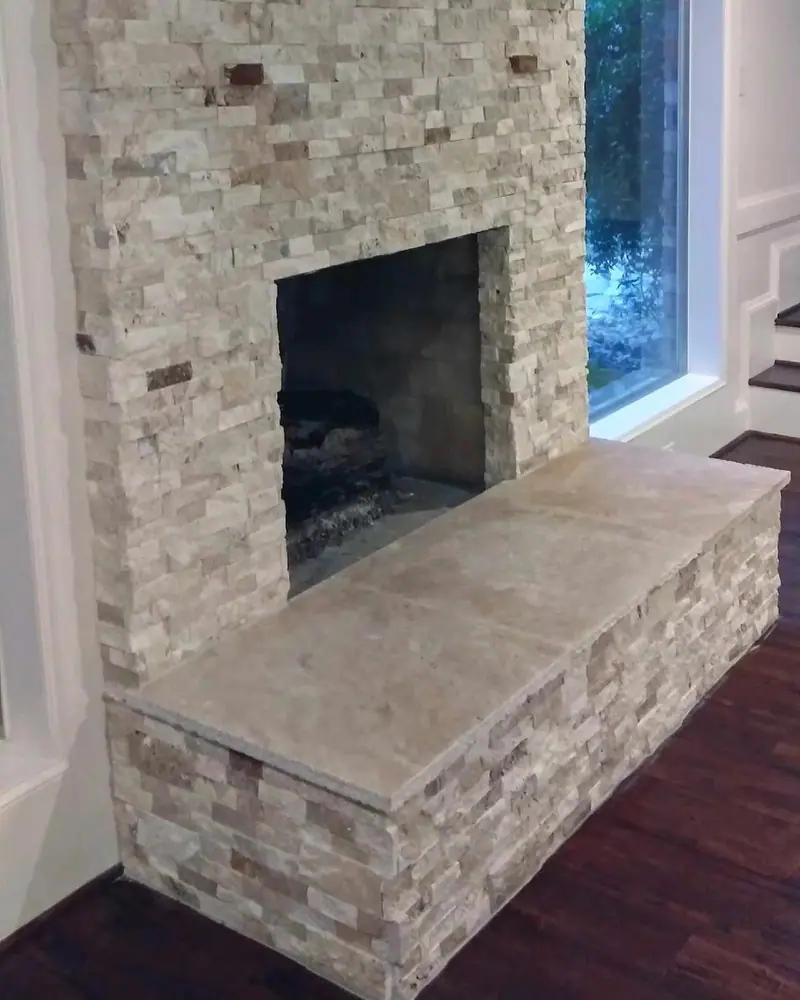 Stacked stone fireplace surround with a stone hearth