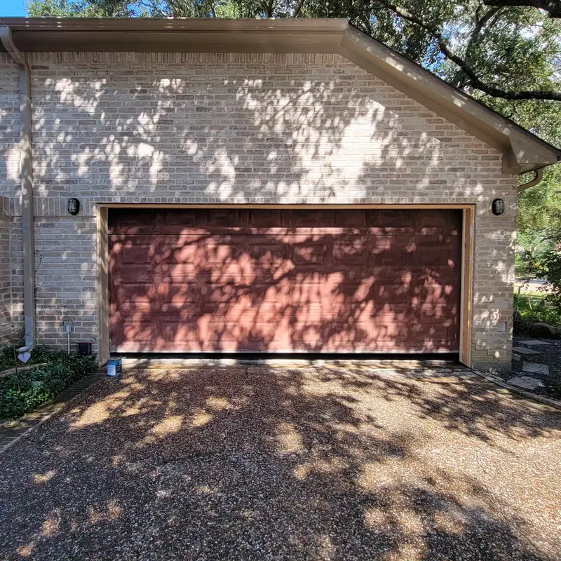 Finished brick wall above a garage door opening
