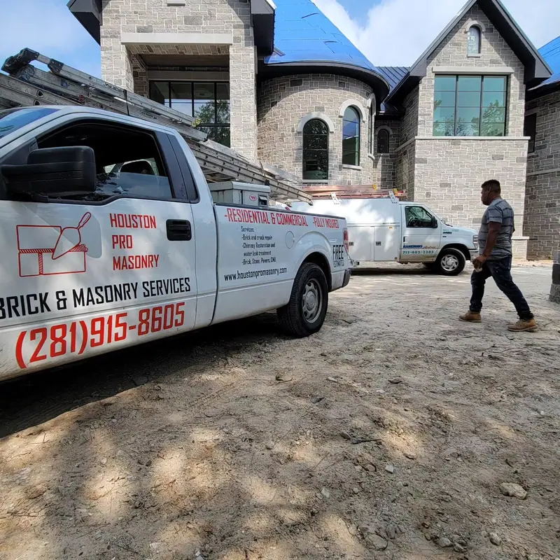 Houston Pro Masonry truck parked at a brick and stone home