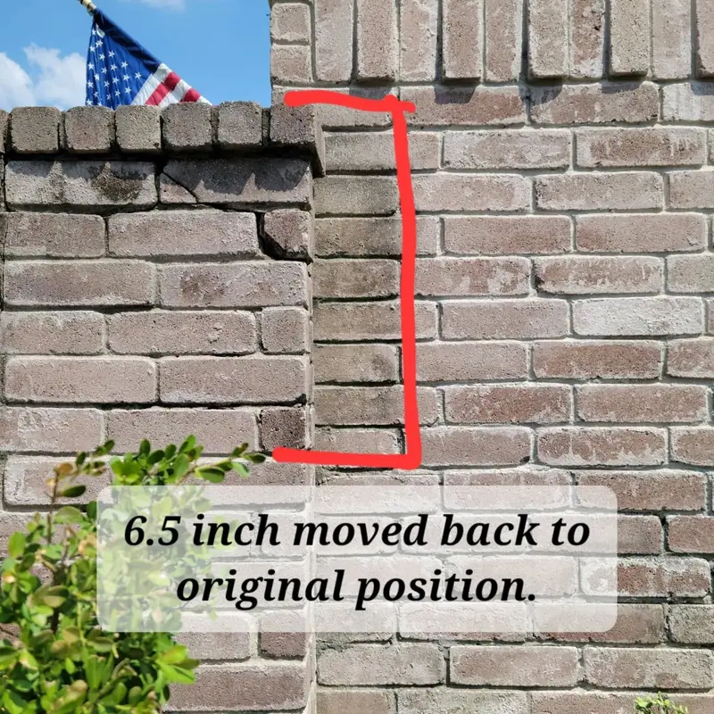 Leaning brick wall section with a note reading "6.5 inch moved back to original position"