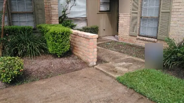 The low entry wall rebuilt beside the front walk