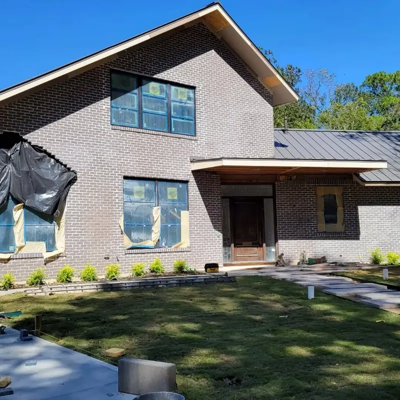 Modern two-story home with gray brick before finish work