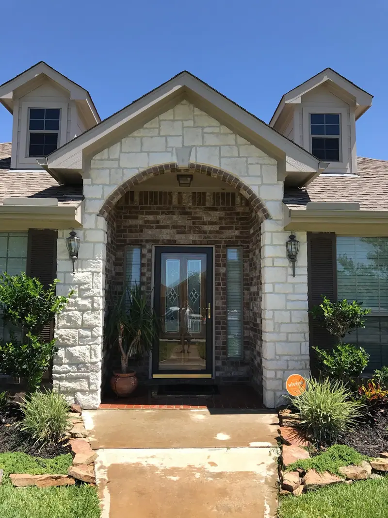 Natural stone around a front entry below a gable