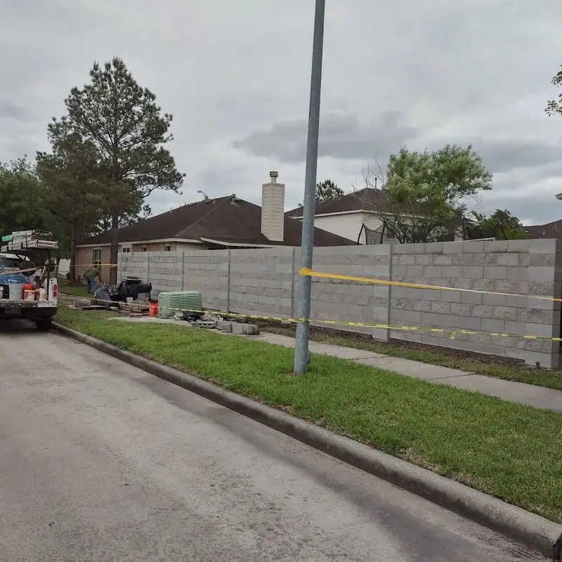 Long perimeter wall along a neighborhood street