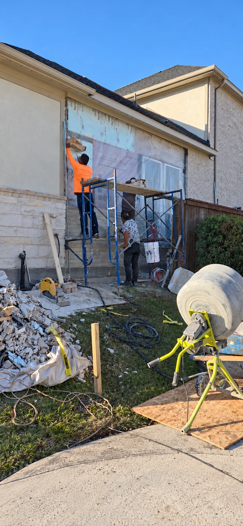 Brick wall being rebuilt after a vehicle struck the home